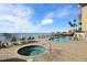 Relaxing waterfront pool and hot tub area with lounge chairs at 1420 Bayshore Blvd # 209, Dunedin, FL 34698