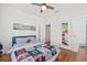 Well-lit bedroom with hardwood floors, ceiling fan, and closet at 213 W Cayuga St, Tampa, FL 33603