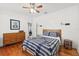 Spacious bedroom with hardwood floors, ceiling fan, and dresser at 213 W Cayuga St, Tampa, FL 33603