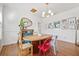 Charming dining room with hardwood floors, oval wooden table and eclectic decor at 213 W Cayuga St, Tampa, FL 33603