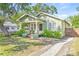 Light green craftsman home with a spacious front yard and walkway at 213 W Cayuga St, Tampa, FL 33603