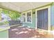 Inviting front porch with a wooden swing, providing a relaxing outdoor space at 213 W Cayuga St, Tampa, FL 33603
