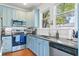 Modern kitchen with stainless steel appliances and light blue cabinets at 213 W Cayuga St, Tampa, FL 33603