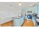 Renovated kitchen featuring light blue cabinetry, granite countertops, and stainless steel appliances at 213 W Cayuga St, Tampa, FL 33603