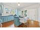 Modern kitchen with light blue cabinets, a large island, and stainless steel appliances at 213 W Cayuga St, Tampa, FL 33603
