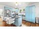 Modern kitchen with light blue cabinets, a large island, and stainless steel appliances at 213 W Cayuga St, Tampa, FL 33603