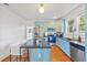 Charming kitchen with light blue cabinets, granite countertops, and stainless steel appliances at 213 W Cayuga St, Tampa, FL 33603