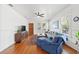 Bright living room with hardwood floors, comfy seating, and large windows at 213 W Cayuga St, Tampa, FL 33603