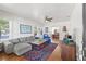 Spacious living room featuring hardwood floors, comfortable seating, and ample natural light at 213 W Cayuga St, Tampa, FL 33603