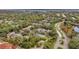 Aerial view of community featuring lush landscaping, tennis court, and waterfront access at 2279 Portofino Pl # 20-2025, Palm Harbor, FL 34683