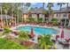 Inviting community pool with plenty of lounge chairs and umbrellas at 2279 Portofino Pl # 20-2025, Palm Harbor, FL 34683