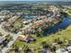 Aerial view of a luxurious community with a golf course and lake at 2337 Platinum Dr, Sun City Center, FL 33573