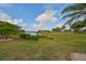 Landscaped backyard with pond view at 2337 Platinum Dr, Sun City Center, FL 33573