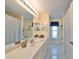 Clean bathroom with double vanity, shower/tub combo, and tile floor at 2337 Platinum Dr, Sun City Center, FL 33573
