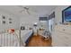 Charming bedroom with hardwood floors, white dresser, and rocking chair at 2337 Platinum Dr, Sun City Center, FL 33573