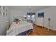 Bright bedroom with hardwood floors and a brass bed frame at 2337 Platinum Dr, Sun City Center, FL 33573
