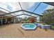 Octagonal hot tub with a decorative tile border, under a screened-in patio at 2337 Platinum Dr, Sun City Center, FL 33573