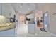 Well-lit kitchen featuring white cabinets, granite counters, stainless appliances, and tile backsplash at 2337 Platinum Dr, Sun City Center, FL 33573