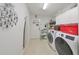Functional laundry room with washer, dryer, and storage at 2337 Platinum Dr, Sun City Center, FL 33573