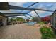 Wide angle shot of large, screened-in patio, complete with Jacuzzi, seating and plants at 2337 Platinum Dr, Sun City Center, FL 33573