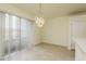 Dining area with chandelier and sliding glass doors at 24311 Breezy Oak Ct, Lutz, FL 33559