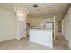 Dining room with chandelier and kitchen views at 24311 Breezy Oak Ct, Lutz, FL 33559