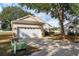 House exterior showcasing a white garage door and landscaping at 24311 Breezy Oak Ct, Lutz, FL 33559