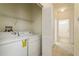 Laundry room with washer, dryer, and additional storage at 24311 Breezy Oak Ct, Lutz, FL 33559