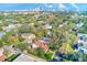 Aerial view showcasing a tree-lined neighborhood and city skyline at 2433 W Watrous Ave, Tampa, FL 33629