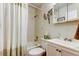 Standard bathroom featuring shower with shower curtain and vanity with mirror at 2460 Persian Dr # 26, Clearwater, FL 33763