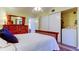 Bedroom featuring a large dresser, closet, ceiling fan, and wood floors at 2460 Persian Dr # 26, Clearwater, FL 33763