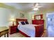 Bedroom with wood floors, large red dresser, and a plush white bed at 2460 Persian Dr # 26, Clearwater, FL 33763