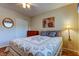 Inviting bedroom with ceiling fan, art, and wood laminate flooring at 2460 Persian Dr # 26, Clearwater, FL 33763