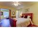 Bedroom with wood floors, ceiling fan, and access to a sitting area at 2460 Persian Dr # 26, Clearwater, FL 33763