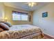 Comfortable bedroom with ceiling fan, window, and cozy decor and wood laminate flooring at 2460 Persian Dr # 26, Clearwater, FL 33763