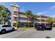 Condominium exterior featuring brick accents, balconies, and well-maintained landscaping at 2460 Persian Dr # 26, Clearwater, FL 33763