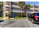 Condo building entrance with parking spaces at 2460 Persian Dr # 26, Clearwater, FL 33763