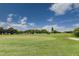 Expansive green golf course putting green with flag and blue sky at 2460 Persian Dr # 26, Clearwater, FL 33763
