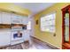 This kitchen features laminate floors, and is open to a breakfast nook and living room at 2460 Persian Dr # 26, Clearwater, FL 33763