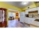 Bright kitchen boasts white cabinets, mosaic tile backsplash, and stainless steel appliances at 2460 Persian Dr # 26, Clearwater, FL 33763