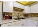 Bright kitchen with stainless steel sink and matching appliances at 2460 Persian Dr # 26, Clearwater, FL 33763