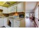 Efficient kitchen features white appliances and opens to an inviting living space at 2460 Persian Dr # 26, Clearwater, FL 33763