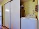 Bright laundry area features a washer and closet with sliding doors for convenience at 2460 Persian Dr # 26, Clearwater, FL 33763