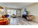 Comfortable living area with wood-look flooring and natural light from a large window at 2460 Persian Dr # 26, Clearwater, FL 33763