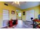 Bright living room with wood floors, ceiling fan, and built-in shelving at 2460 Persian Dr # 26, Clearwater, FL 33763