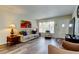 Cozy living room featuring wood-look flooring, neutral paint, and ample natural light at 2460 Persian Dr # 26, Clearwater, FL 33763