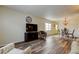 Bright living room with wood-look floors offering a view to the dining area at 2460 Persian Dr # 26, Clearwater, FL 33763