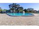 Inviting community pool with brick pavers and ample lounge space at 2460 Persian Dr # 26, Clearwater, FL 33763