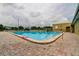 Relaxing community pool area with surrounding lounge chairs at 2460 Persian Dr # 26, Clearwater, FL 33763