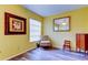 Cozy sitting area with window, framed art, and a decorative chair at 2460 Persian Dr # 26, Clearwater, FL 33763